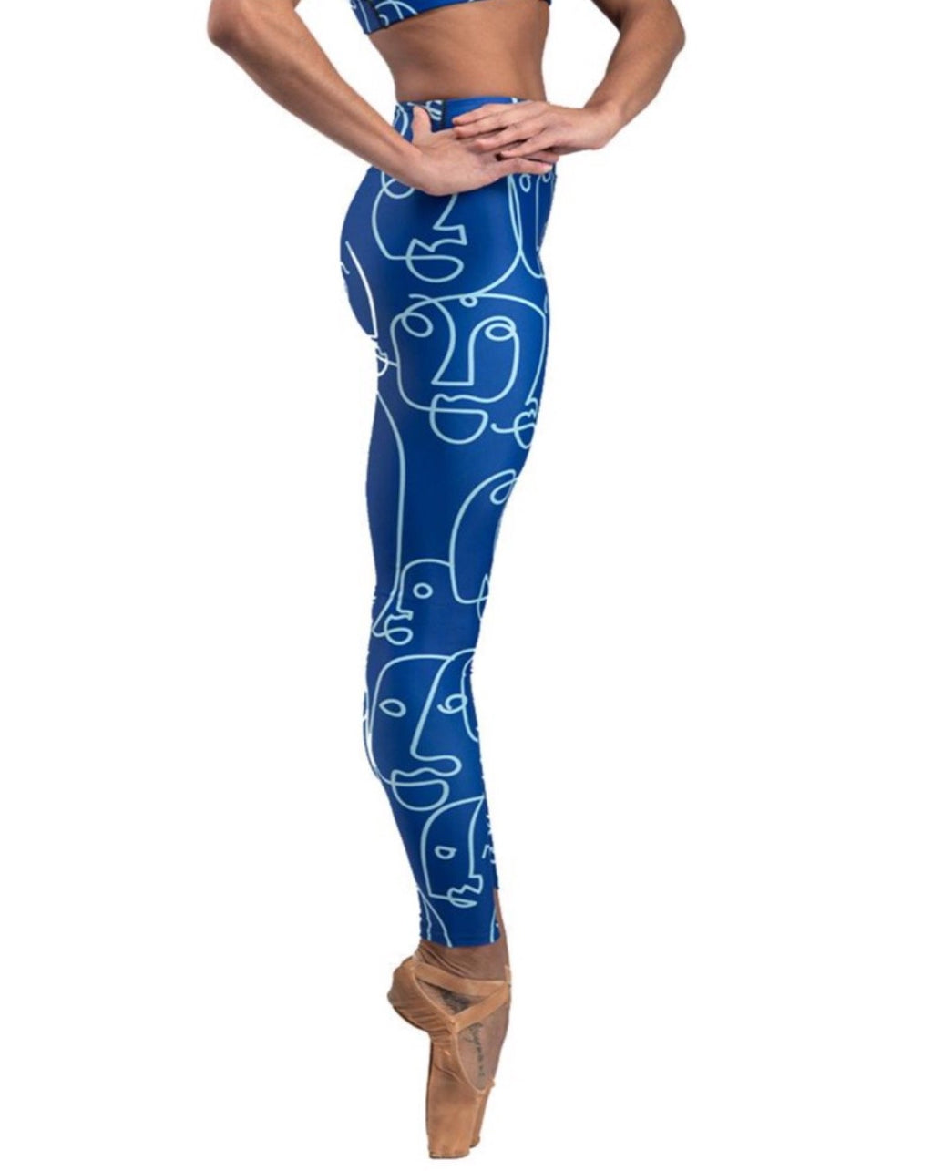 The cool ppl blue mazurka leggings with illustrated faces art modeled by a ballet dancer on pointe.